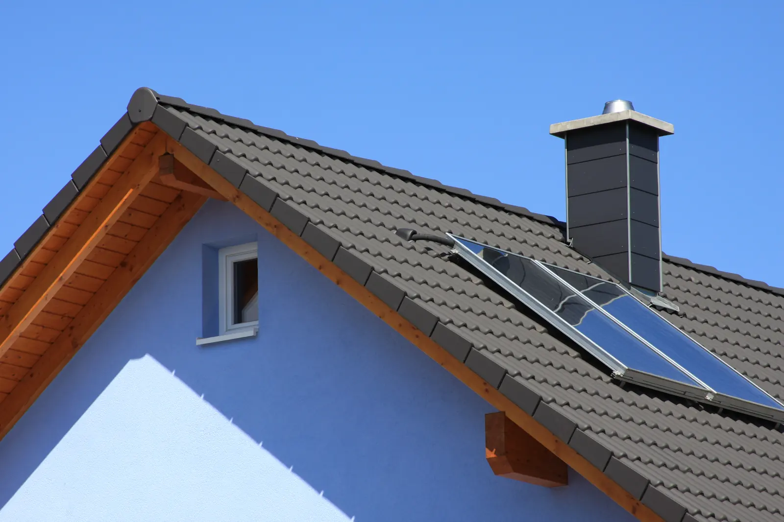 Grey tiled roof with a chimney