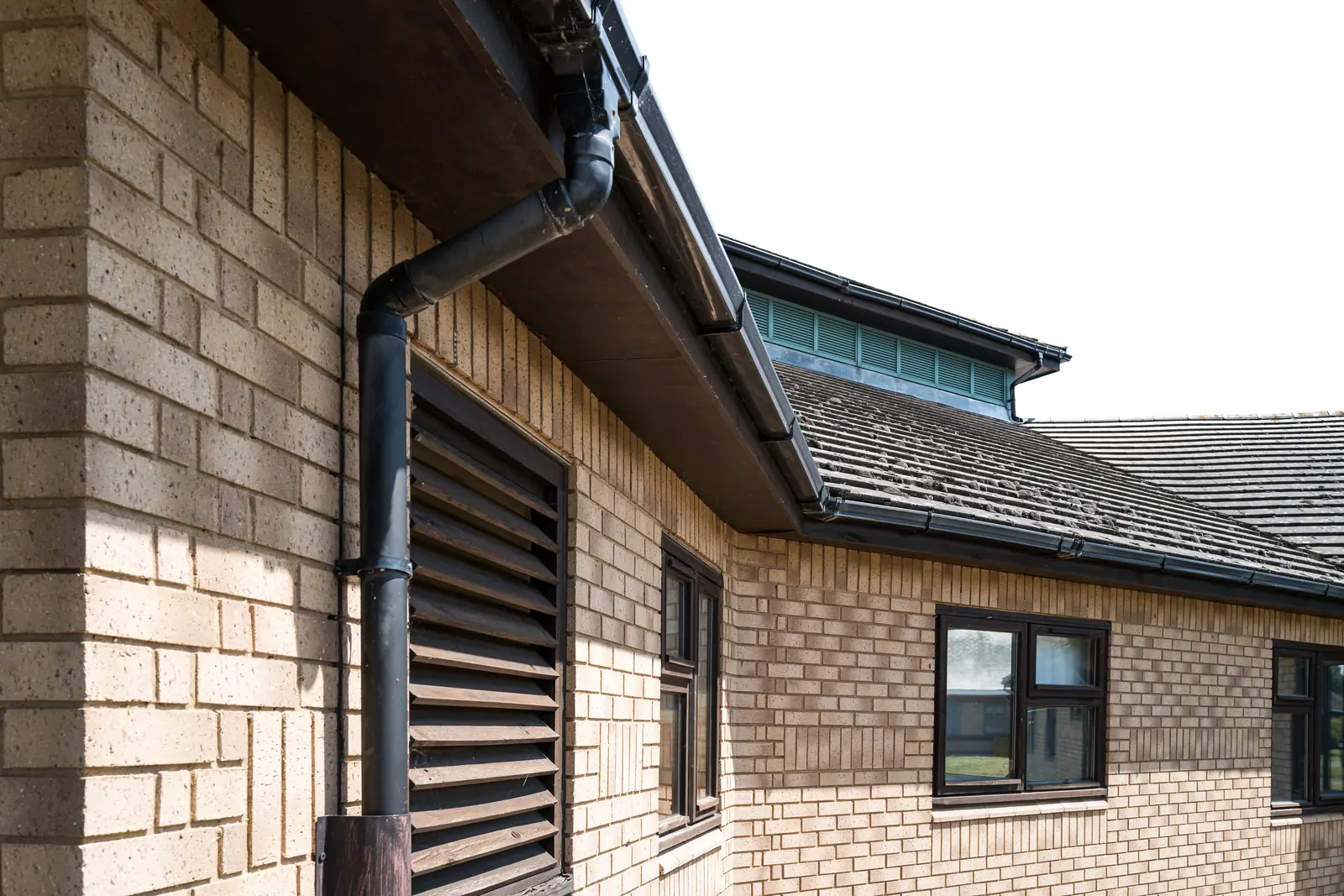 Brick house with new guttering and downpipe