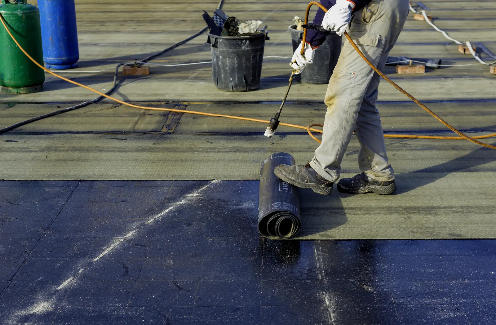 Torch on felt being laid on a flat roof