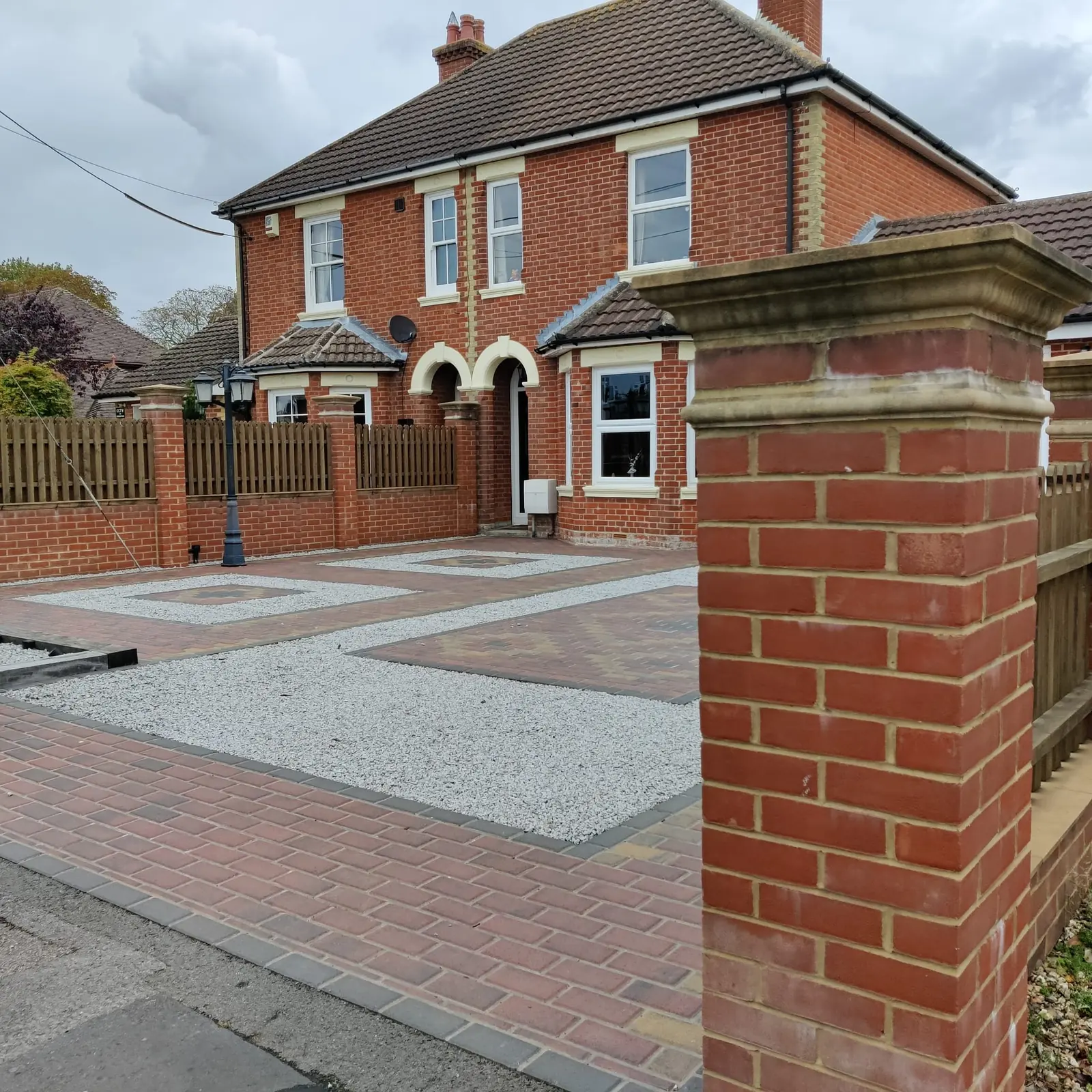 Block paving and gravel driveway in front of a house