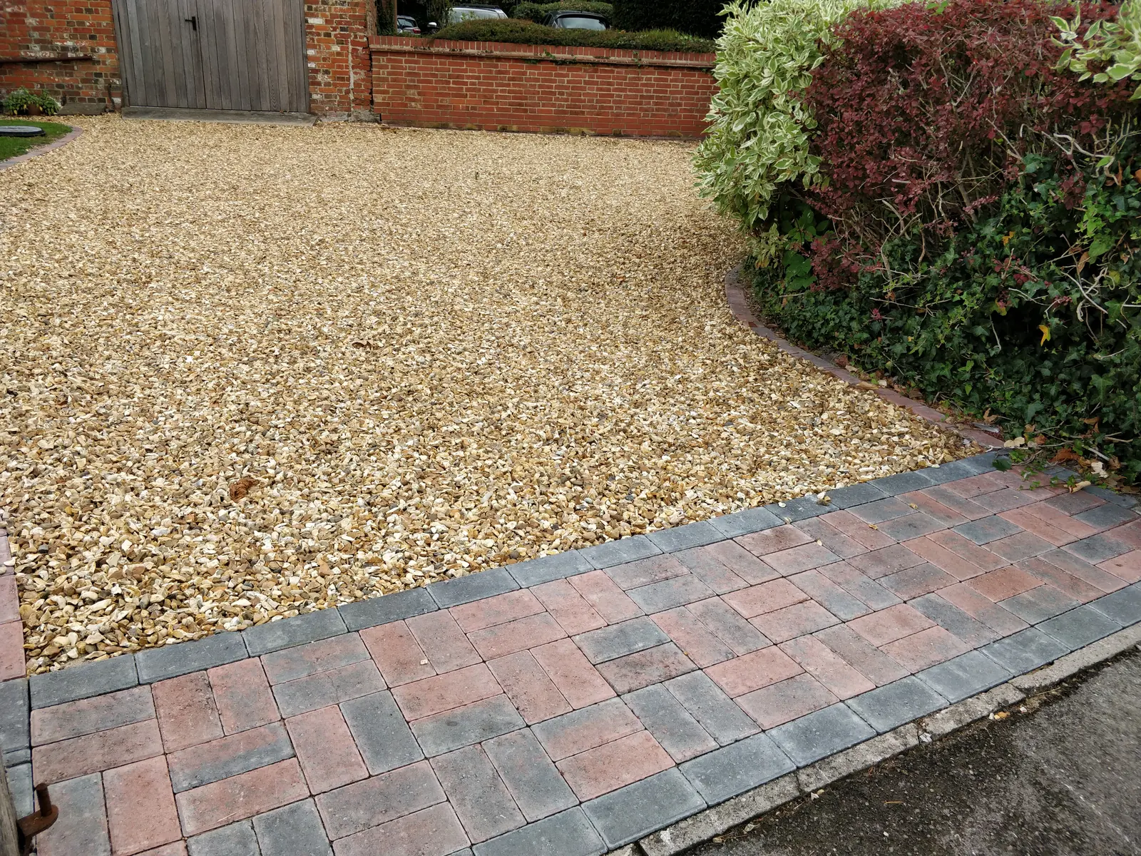 Gravel driveway with red brick edging